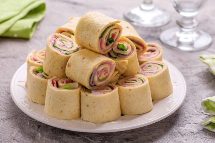 picture of turkey and cheese wraps wrapped in a flour tortilla with vegetables