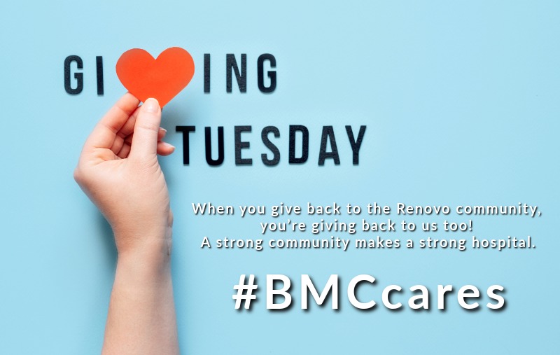 Text reading "Giving Tuesday" with a red paper heart replacing the letter "V," a hand holding the heart, and text below reading "#BMCcares" on a light blue background.