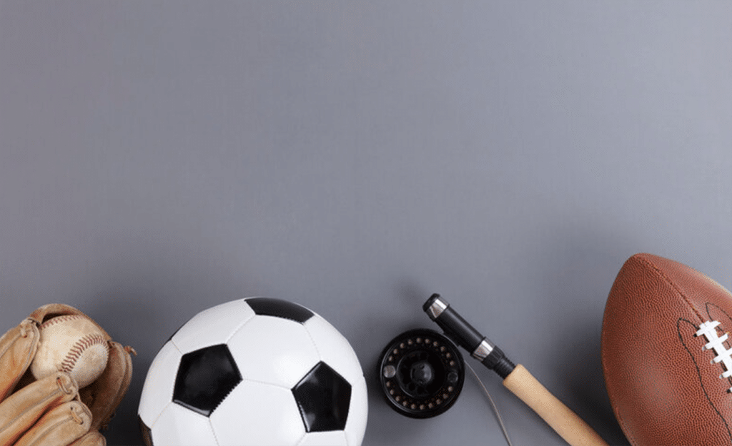 A row of sports equipment—a baseball glove and ball, a soccer ball, a fishing reel and rod, and a football—arranged along the bottom edge of a plain gray background.